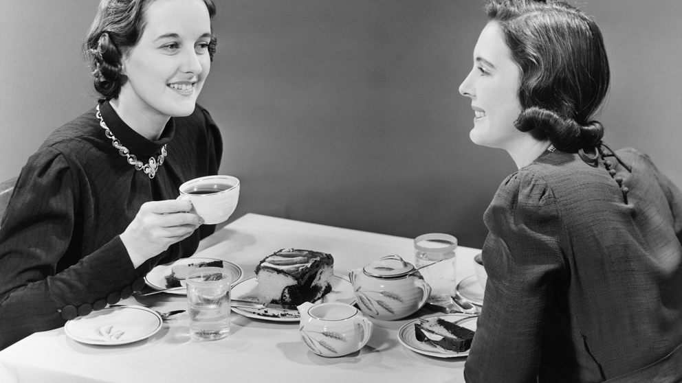 Black and white image of to ladies having tea